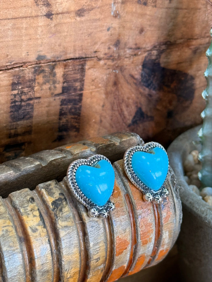 Large turquoise heart stud earrings with silver beaded trim and dangling star charm on post