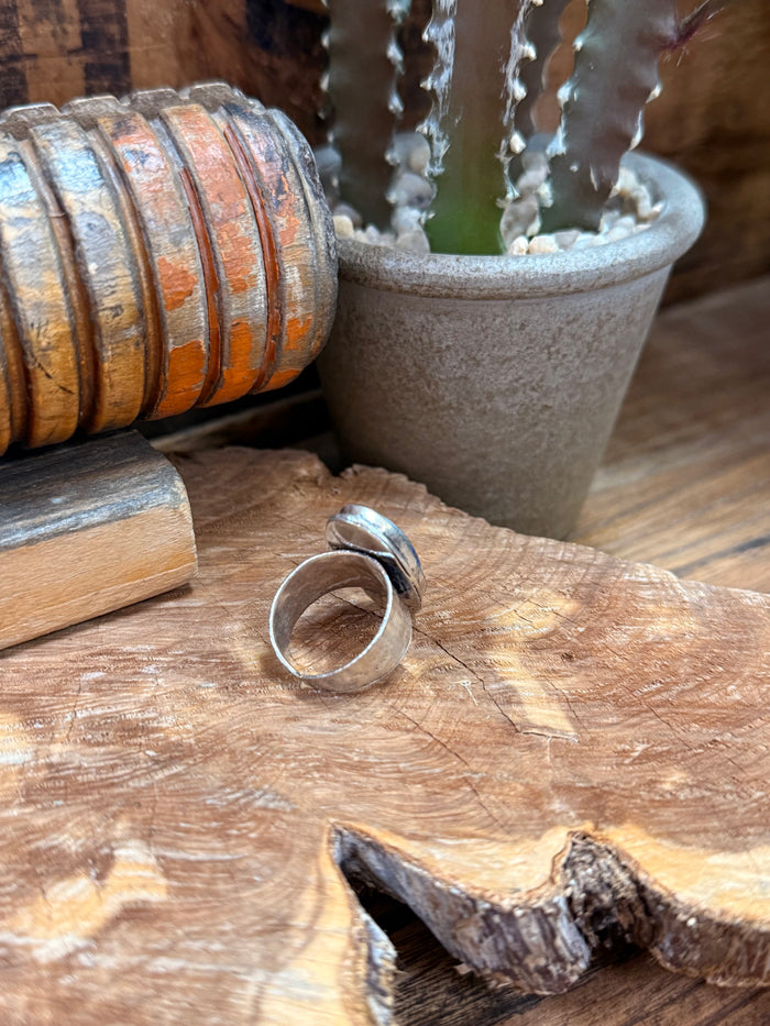 Silver-plated adjustable ring viewed from side with oval blue lapis stone