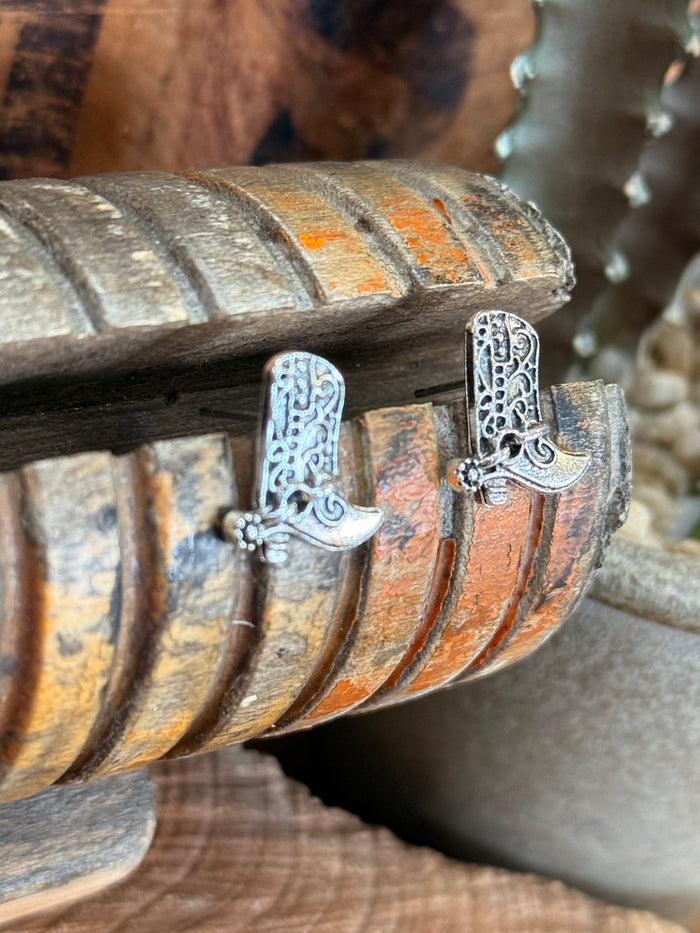 Silver boot spur stud earrings angled view with detailed filigree spur