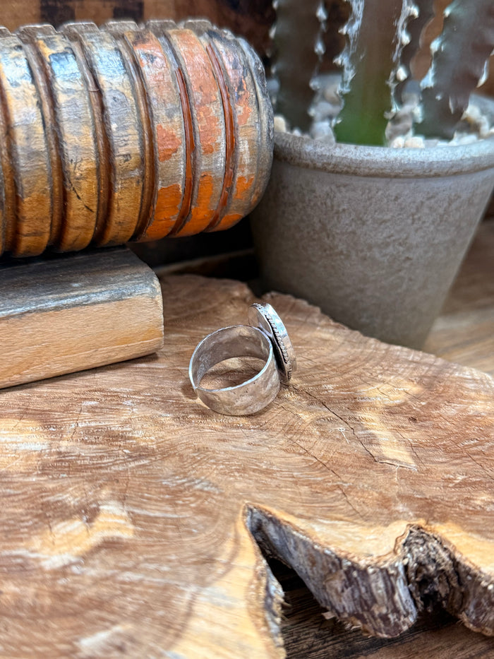 Adjustable silver-plated brass ring with oval stone, side view of the band