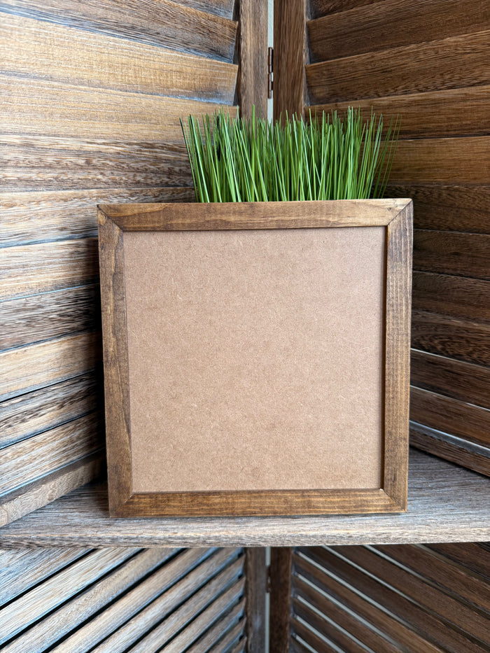 Wooden framed wall art with a blank beige insert
