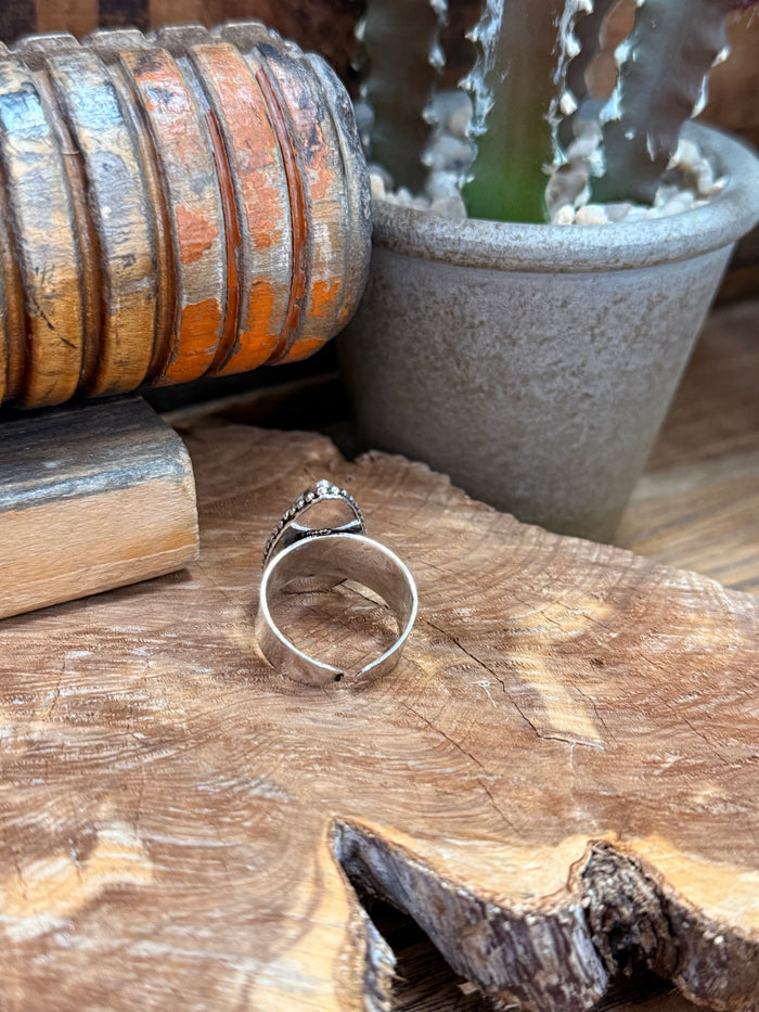 Adjustable silver-tone ring band with blue-gray teardrop stone