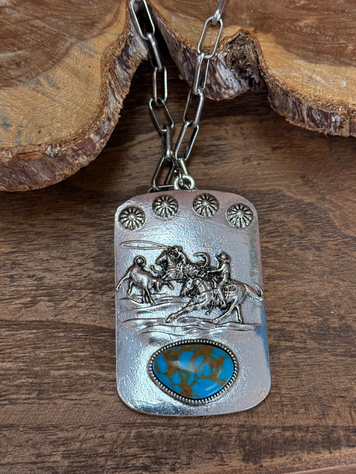 Roping scene pendant necklace with studded top and turquoise-style oval