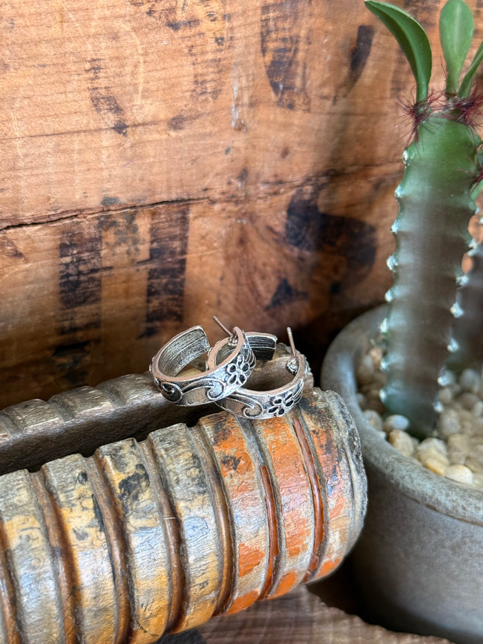 Silver hoop stud earrings with engraved floral motifs and small stud posts