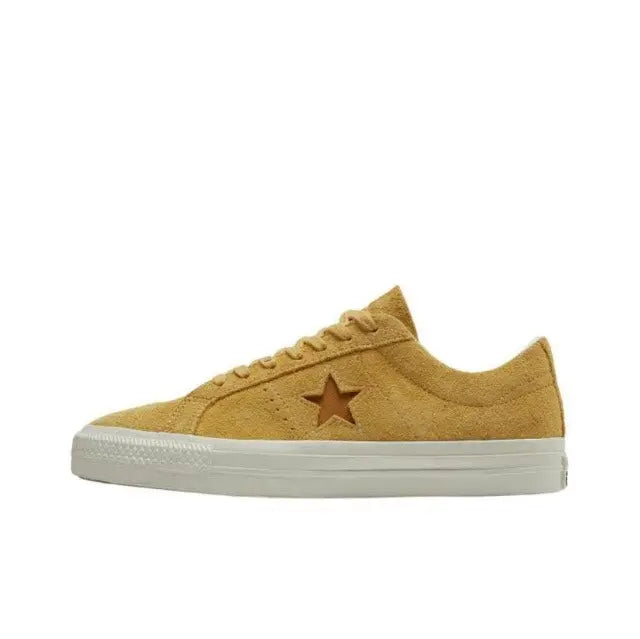 Yellow suede low-top sneaker side view with star logo and white rubber sole