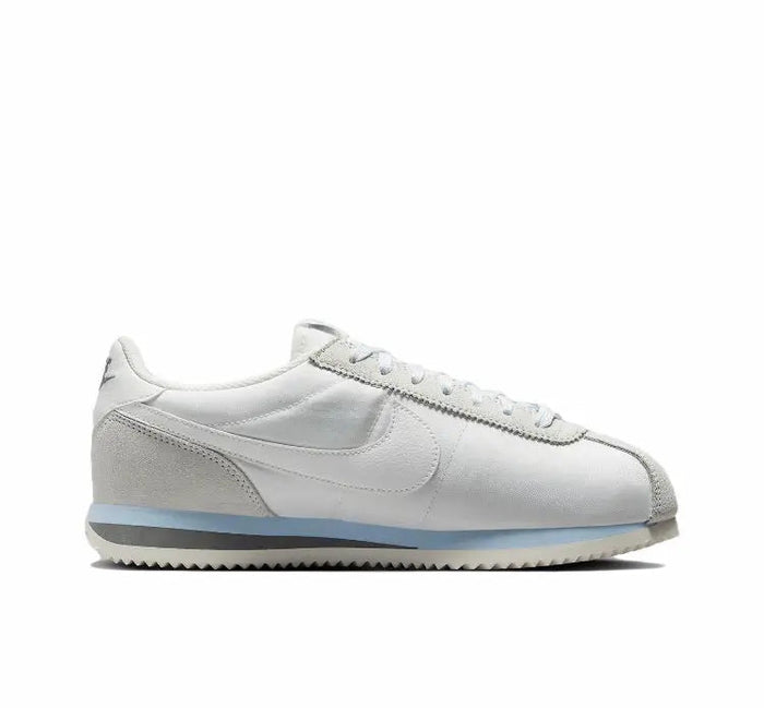 White leather low-top sneakers with lace-up front and side swoosh