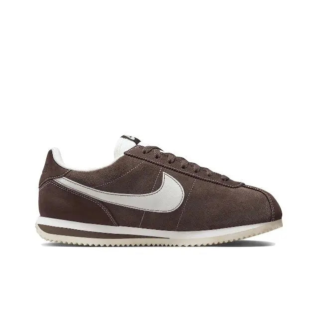 Brown low-top sneakers with white Swoosh and striped rubber sole
