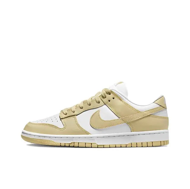 Nike Dunk Low low-top sneaker, side profile in white and light gold with swoosh