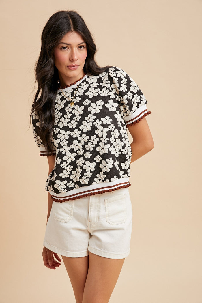 Black floral embossed knit puff-sleeve shirt with ribbed stripe cuffs and hem