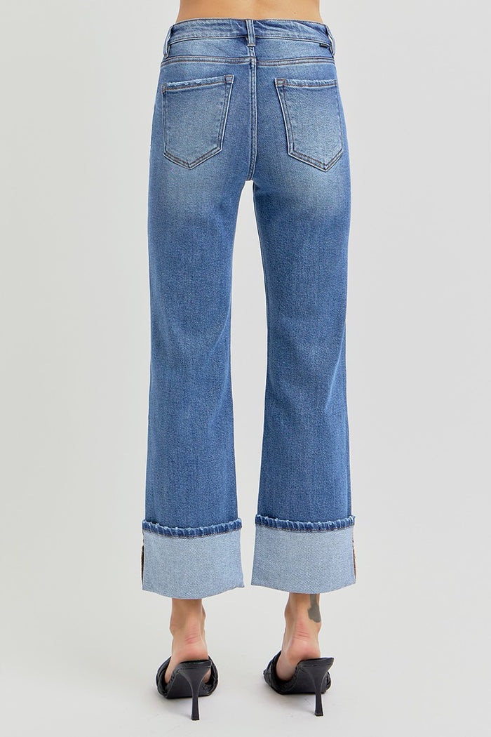 Medium-wash cuffed jeans with front seam and back pockets, straight-leg fit.