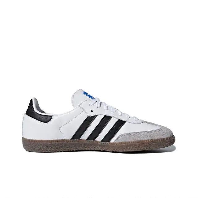 White low-top sneakers with black triple stripes, lace-up closure, and gum midsole