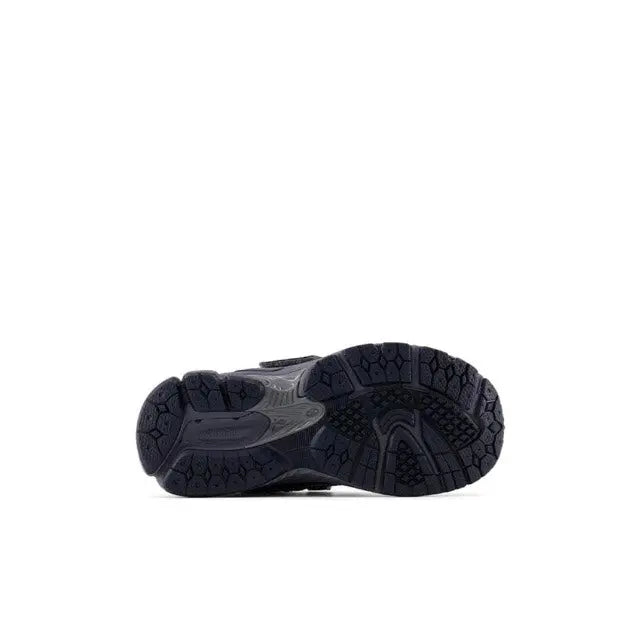Black running shoe outsole with deep tread and textured traction pods