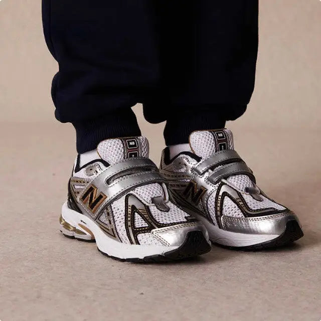 New Balance 1906R sneakers on feet, silver and black lace-up with thick sole
