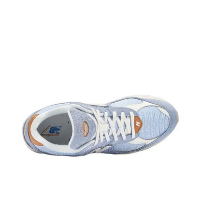 New Balance 2002R sneaker, front view, light blue upper with white laces and tan heel tab