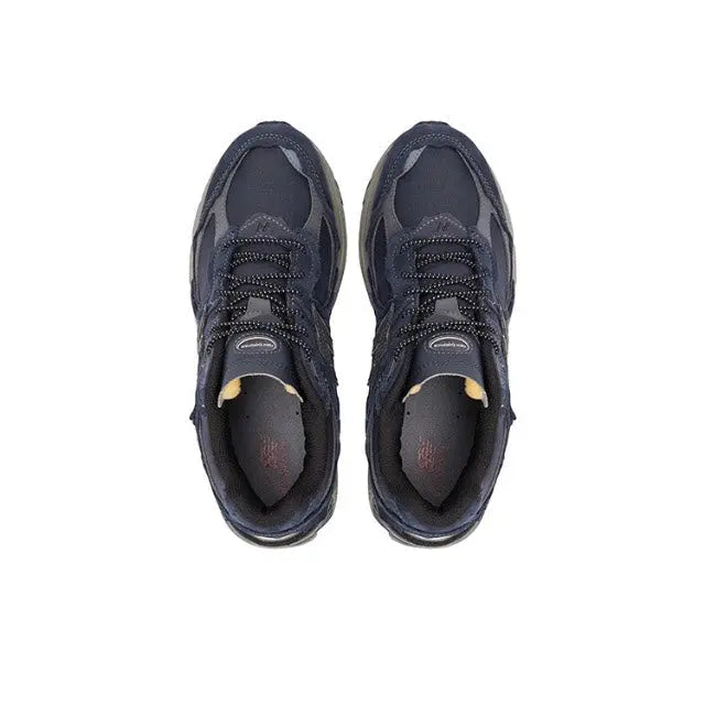 Navy New Balance 2002R sneakers viewed from front, lace-up with cushioned tongue