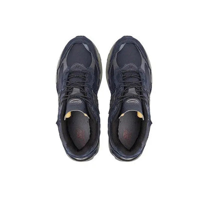 Navy New Balance 2002R sneakers viewed from front, lace-up with cushioned tongue