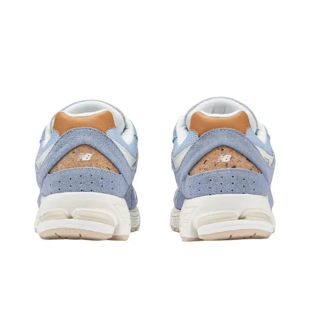 New Balance 2002R sneaker, heel view, light blue with tan suede panel and padded collar