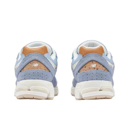 New Balance 2002R sneaker, heel view, light blue with tan suede panel and padded collar