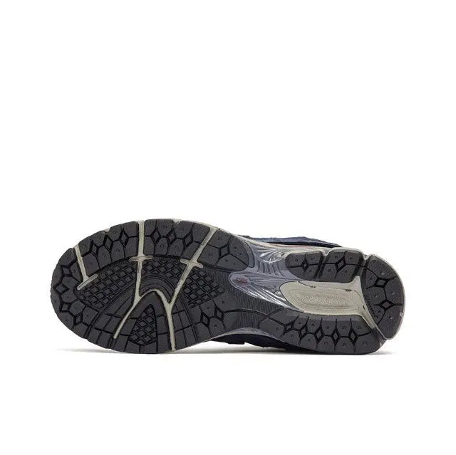 Navy New Balance 2002R outsole view with patterned tread and cushioned midfoot