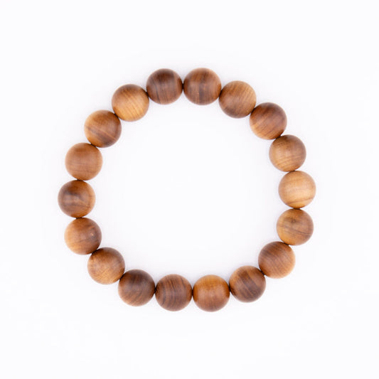 Buy natural sandalwood bracelet with round Mysore wood beads on a white background