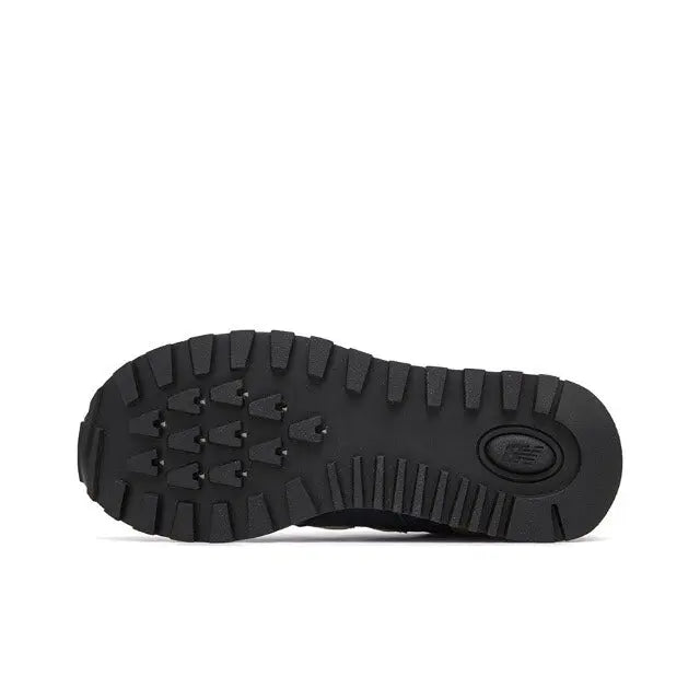Retro running sneaker outsole with black rugged tread and circular logo