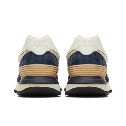 Retro running sneaker heel view, cream uppers with navy panels and tan stripes