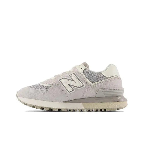 New Balance 574 low-top sneaker in light grey and off-white, side profile, lace-up