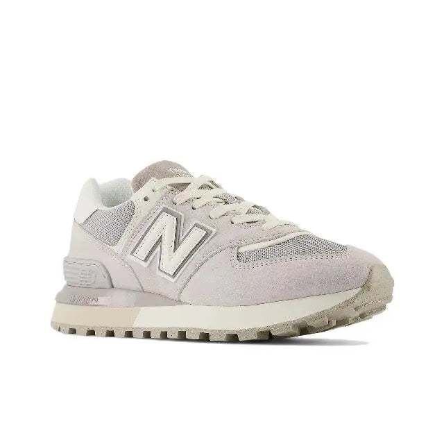 New Balance 574 low-top sneaker in light grey and off-white, front side view, lace-up
