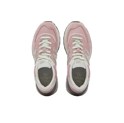 New Balance 574 pink lace-up sneakers with white laces, gray interior, black outsole