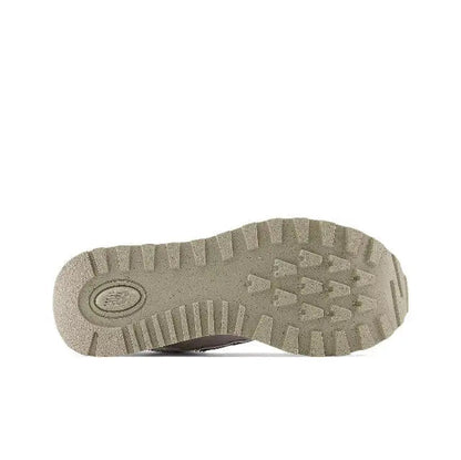 New Balance 574 sneaker outsole with rugged tread pattern in tan-grey