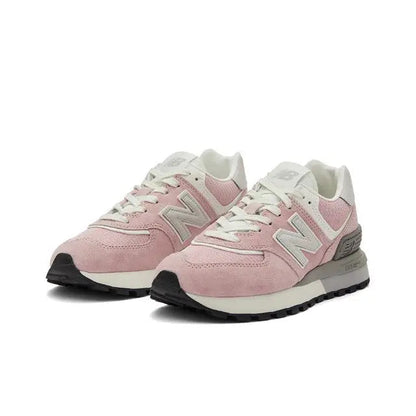 New Balance 574 pink-and-white sneakers with large N logo, lace-up design, black sole