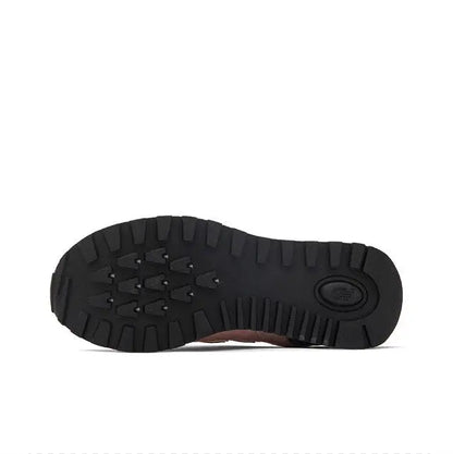 New Balance 574 sneaker outsole with black tread and circular heel logo