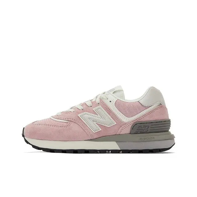 New Balance 574 pink suede sneaker with white N logo and gray striped midsole
