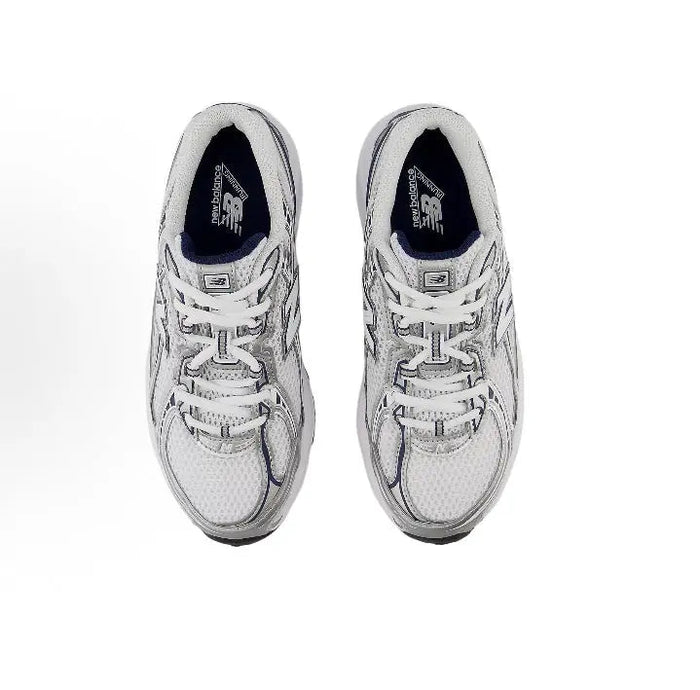 Running shoe side view with lace-up front, light grey upper, and navy lining