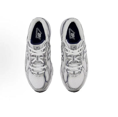 Running shoe side view with lace-up front, light grey upper, and navy lining