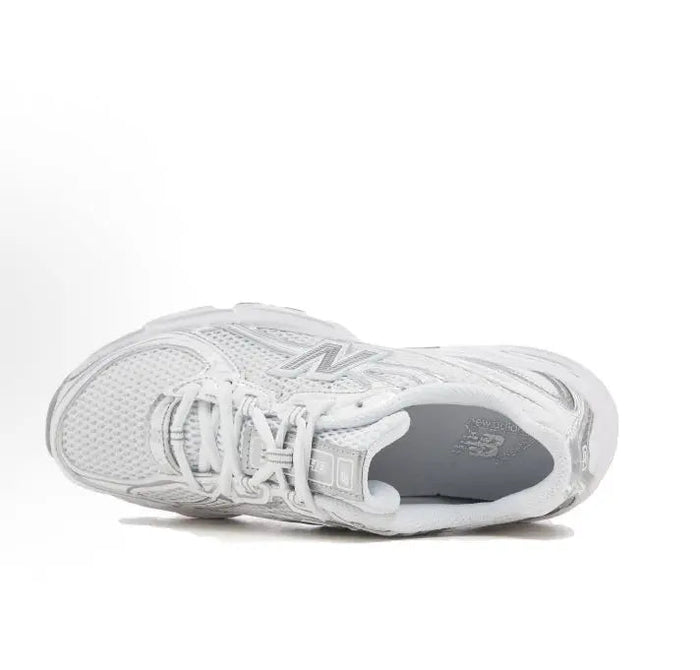 White lace-up sneaker, side view with textured mesh upper and cushioned collar