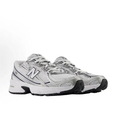 Running shoe in light grey with N logo, lace-up front, and black rubber detail