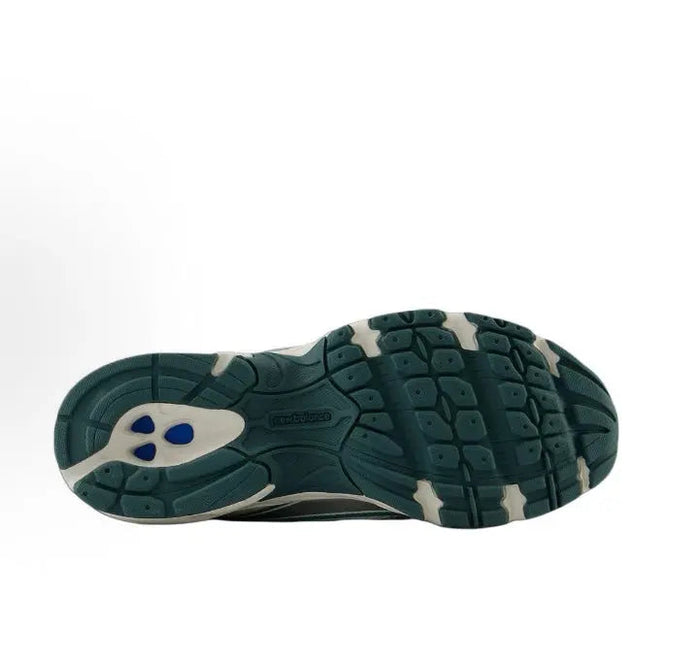 Running sneaker outsole, dark green rubber tread with small blue accent