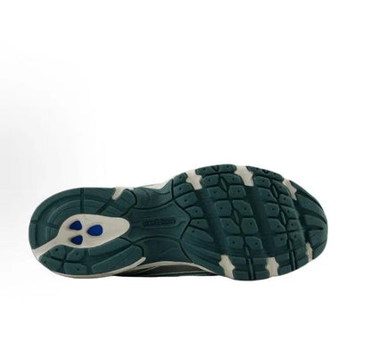 Running sneaker outsole, dark green rubber tread with small blue accent