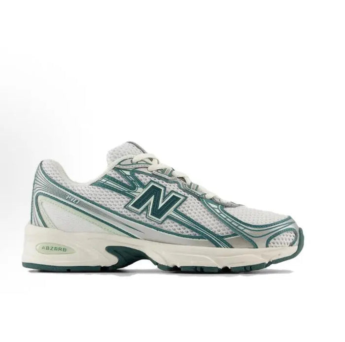 Running sneaker side view, white mesh with green trim and ABZORB logo on midfoot