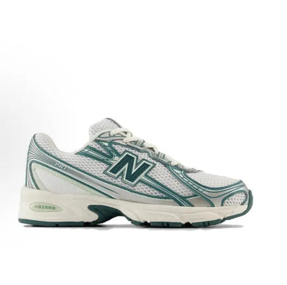 Running sneaker side view, white mesh with green trim and ABZORB logo on midfoot