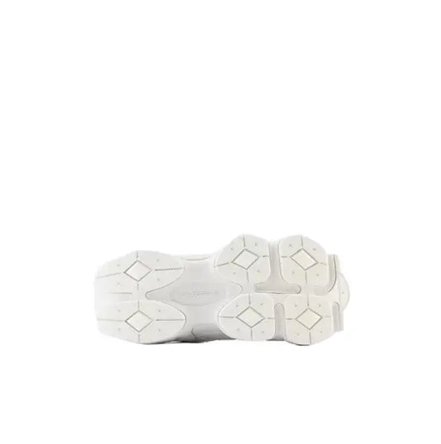 New Balance 9060 white outsole with multi-pattern tread and raised sidewall