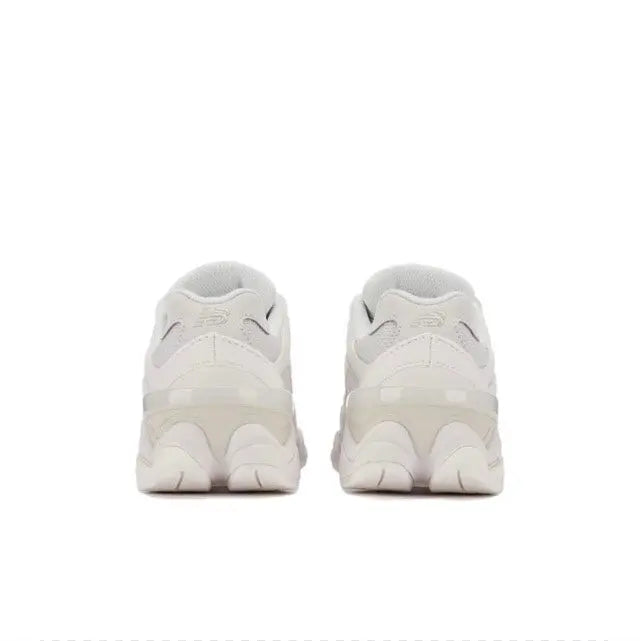 New Balance 9060 white heel pair view with cushioned back and lace-up closure