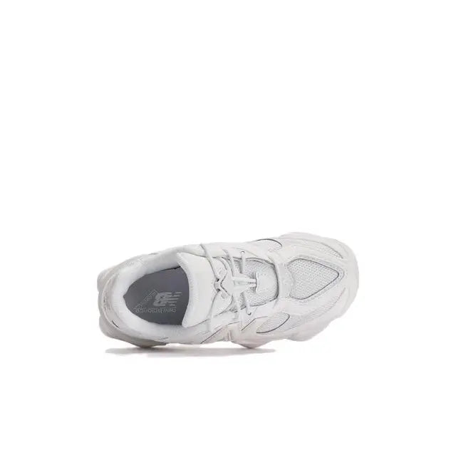 New Balance 9060 white sneaker side view with eyelets, laces, and cushioned collar