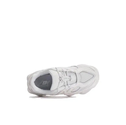 New Balance 9060 white sneaker side view with eyelets, laces, and cushioned collar