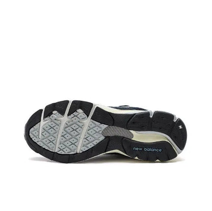 New Balance 990 sneakers outsole view, black and light gray traction pattern.