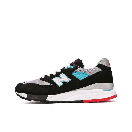 New Balance 998 sneakers, black with white and teal accents, red sole edge