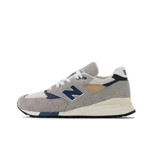 New Balance 998 sneaker in grey with blue accents, suede-look upper, lace-up front