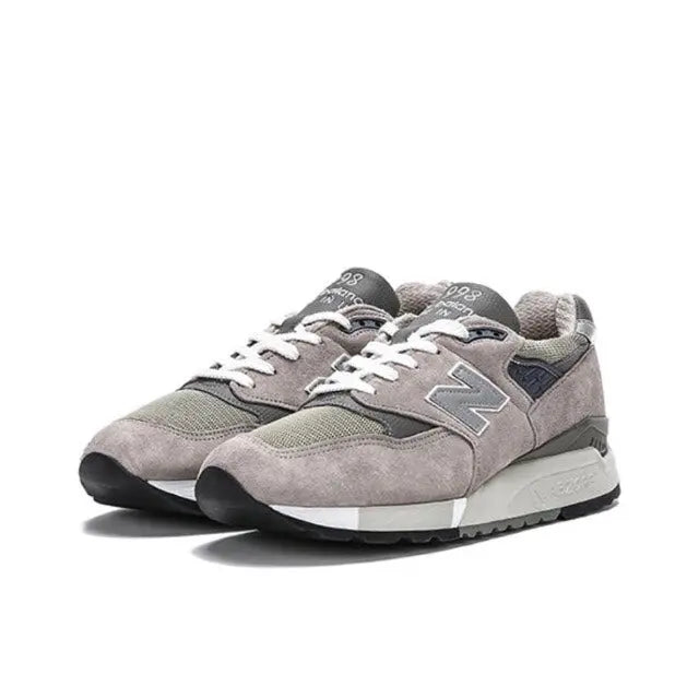 Grey low-top sneakers with N logo, lace-up front, cushioned midsole, rubber outsole