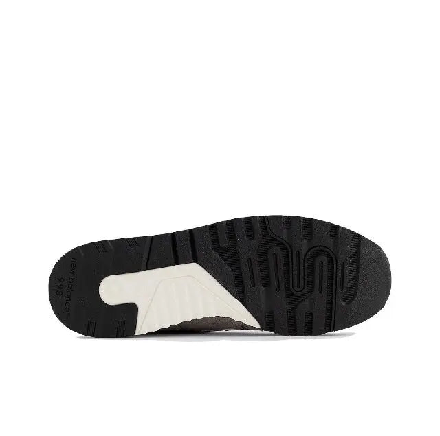 Sneaker outsole with dark rubber tread and light midsole section